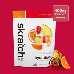 Pouring Skratch Labs Hydration Fruit Punch powder into water for fast hydration