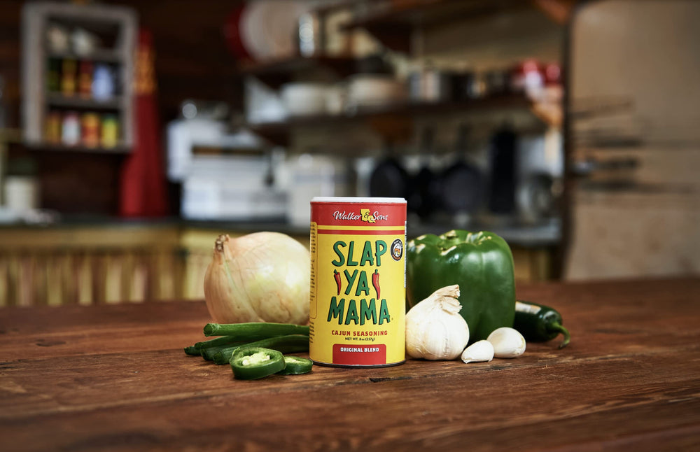 Slap Ya Mama spice shaker dusting vegetables for easy weeknight flavor.