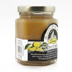 Lemon Crème Honey from Sleeping Bear Farms drizzled on toast with tea setup.