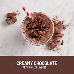 Pouring SlimFast chocolate shake into a glass for a smooth serving.