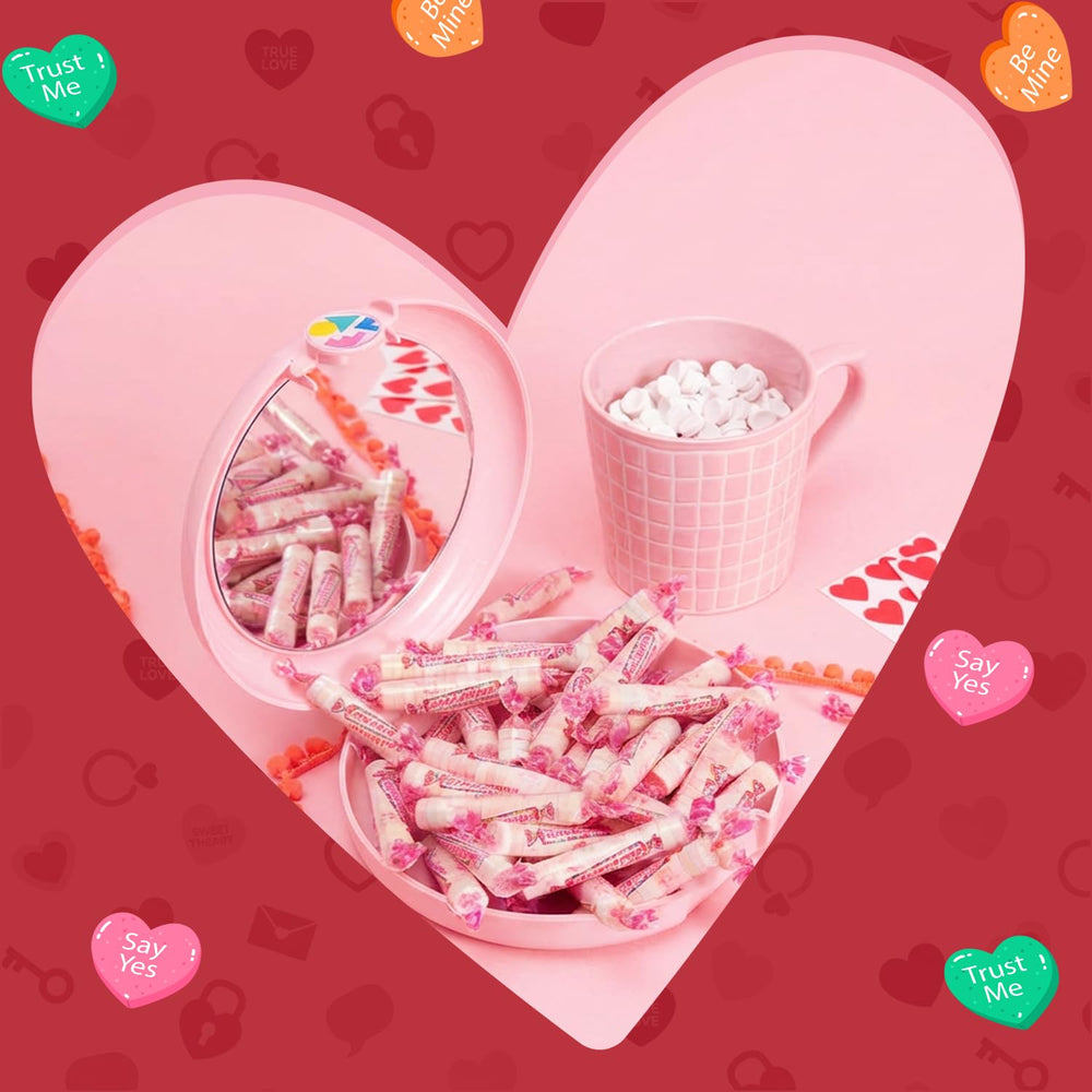 Smarties candy rolls arranged as a party favor on table.