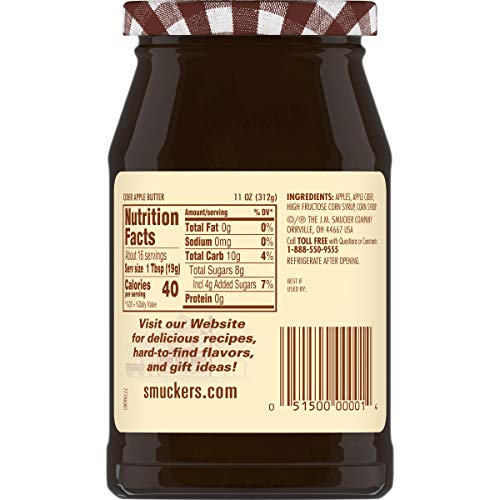 Spoon of Smucker's cider apple butter showing creamy texture.