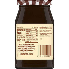 Spoon of Smucker's cider apple butter showing creamy texture.