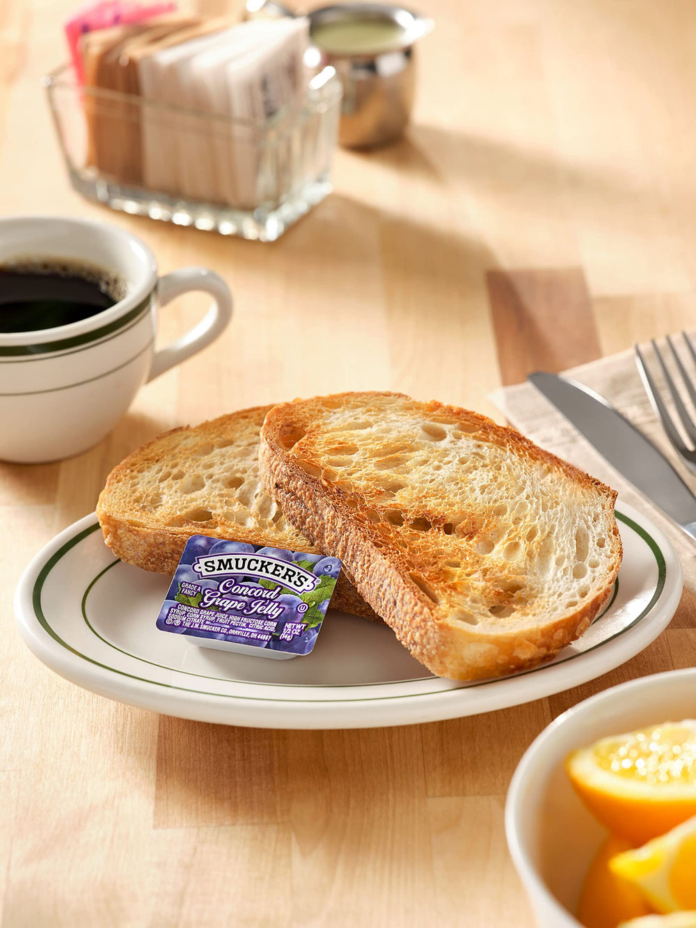 Smucker's Concord grape jelly cups in a caddy for buffet service