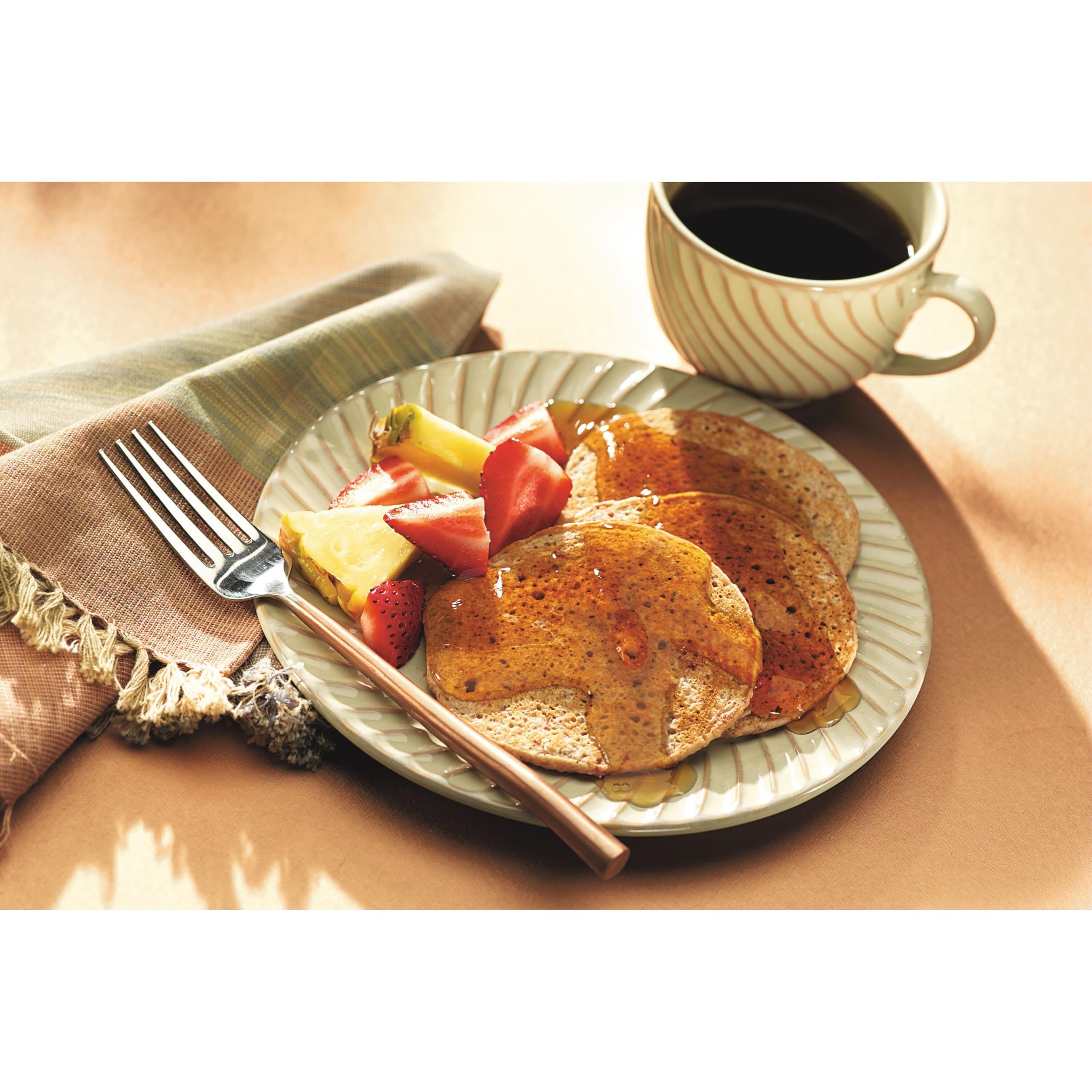 Pouring action of Smucker's Sugar Free Syrup over breakfast items.