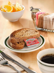 Smucker's tabletop caddy display highlighting three flavors for guests.