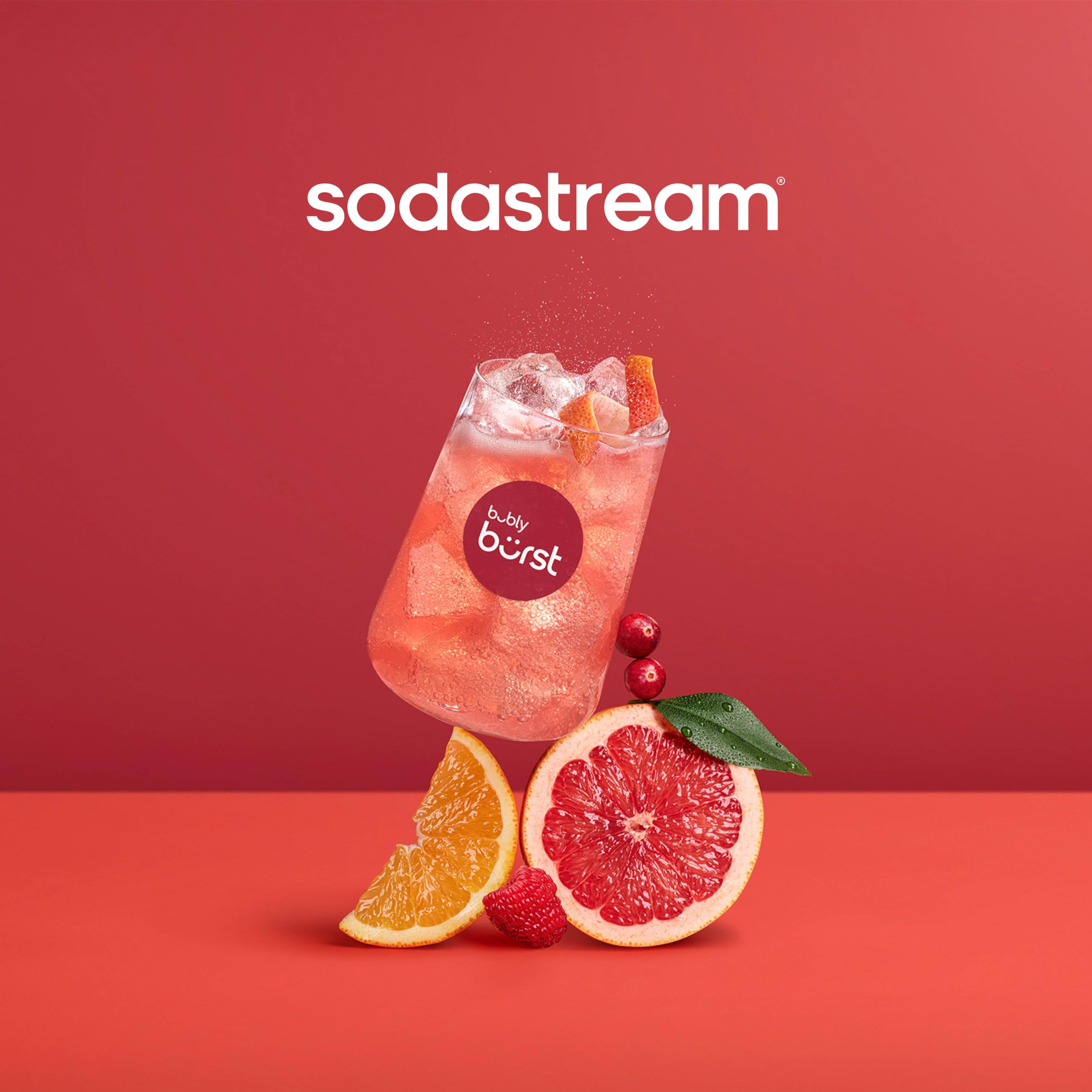 Sodastream Bubly Drops blackberry bottle with glass of sparkling water.
