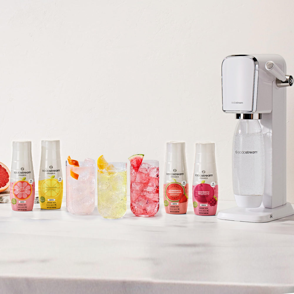 Glass with sparkling water and ice using Sodastream Cranberry Raspberry for a refreshing treat.
