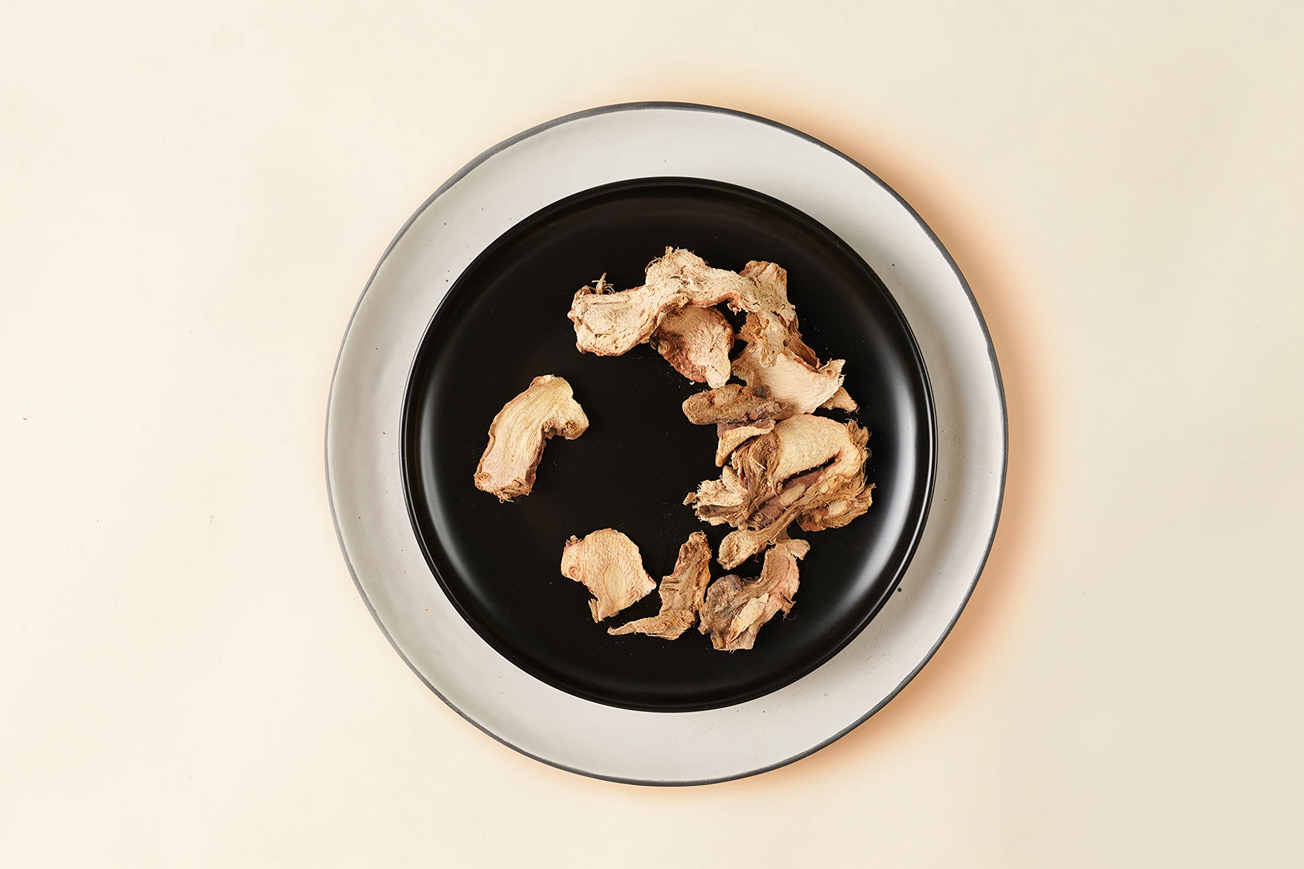 Soeos galangal slices soaking to soften before use in recipes