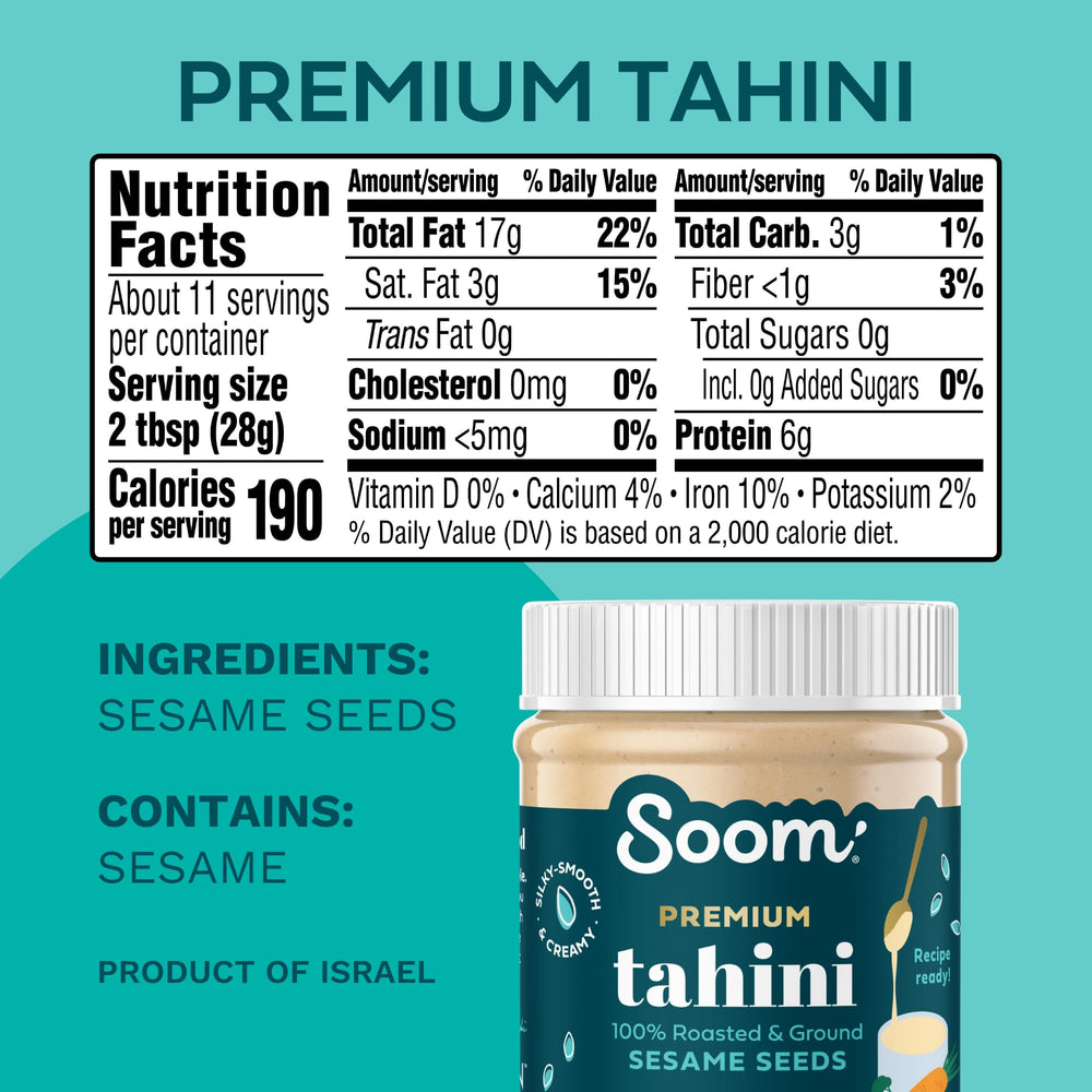 Soom Premium Tahini bottle beside roasted sesame seeds, highlighting a rich, nutty aroma.