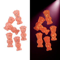 Gummies close-up reveals soft, chewy texture and pink color.