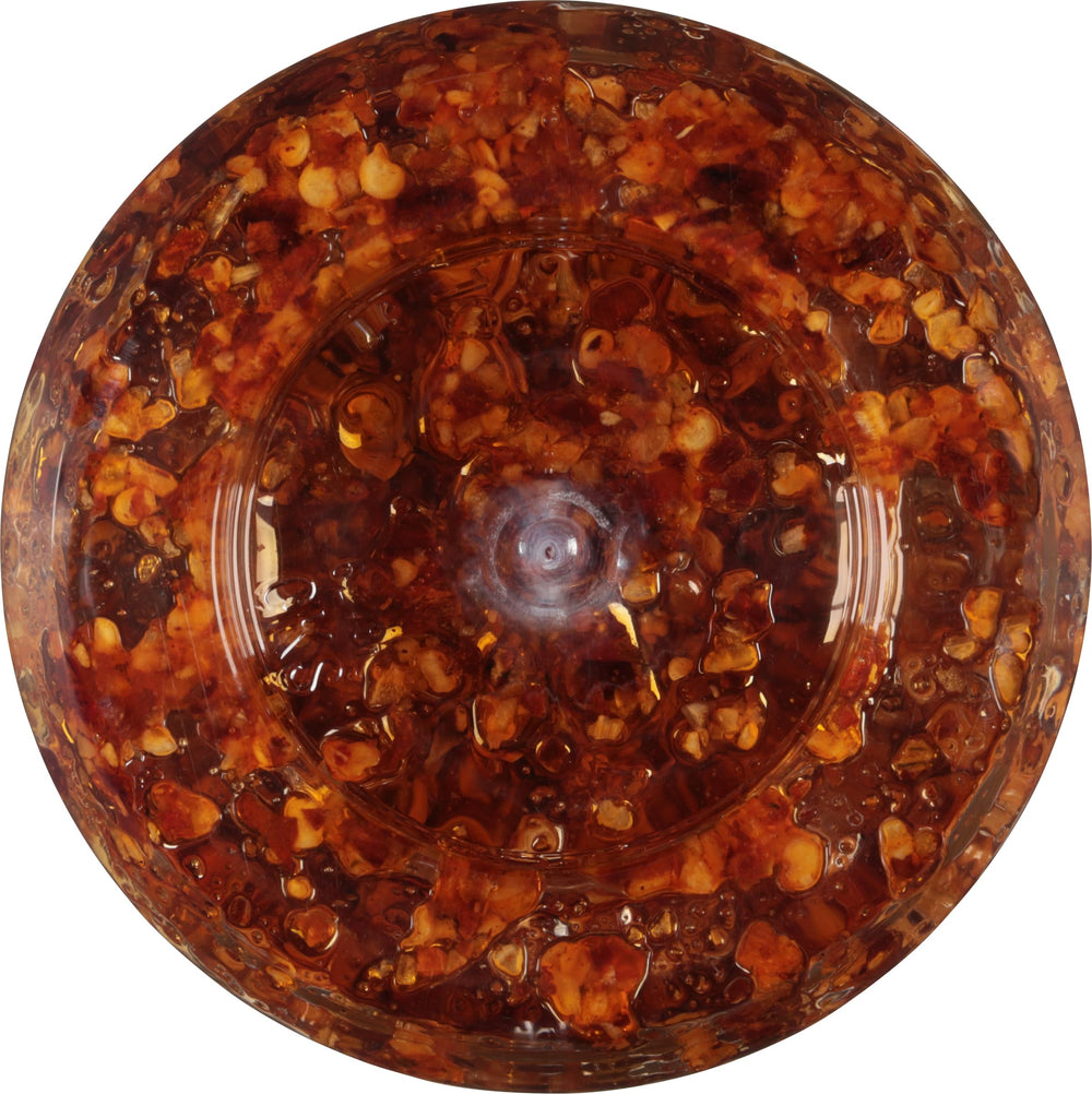 Bottle label of Spice World Chili Onion Crunch in a bright kitchen.