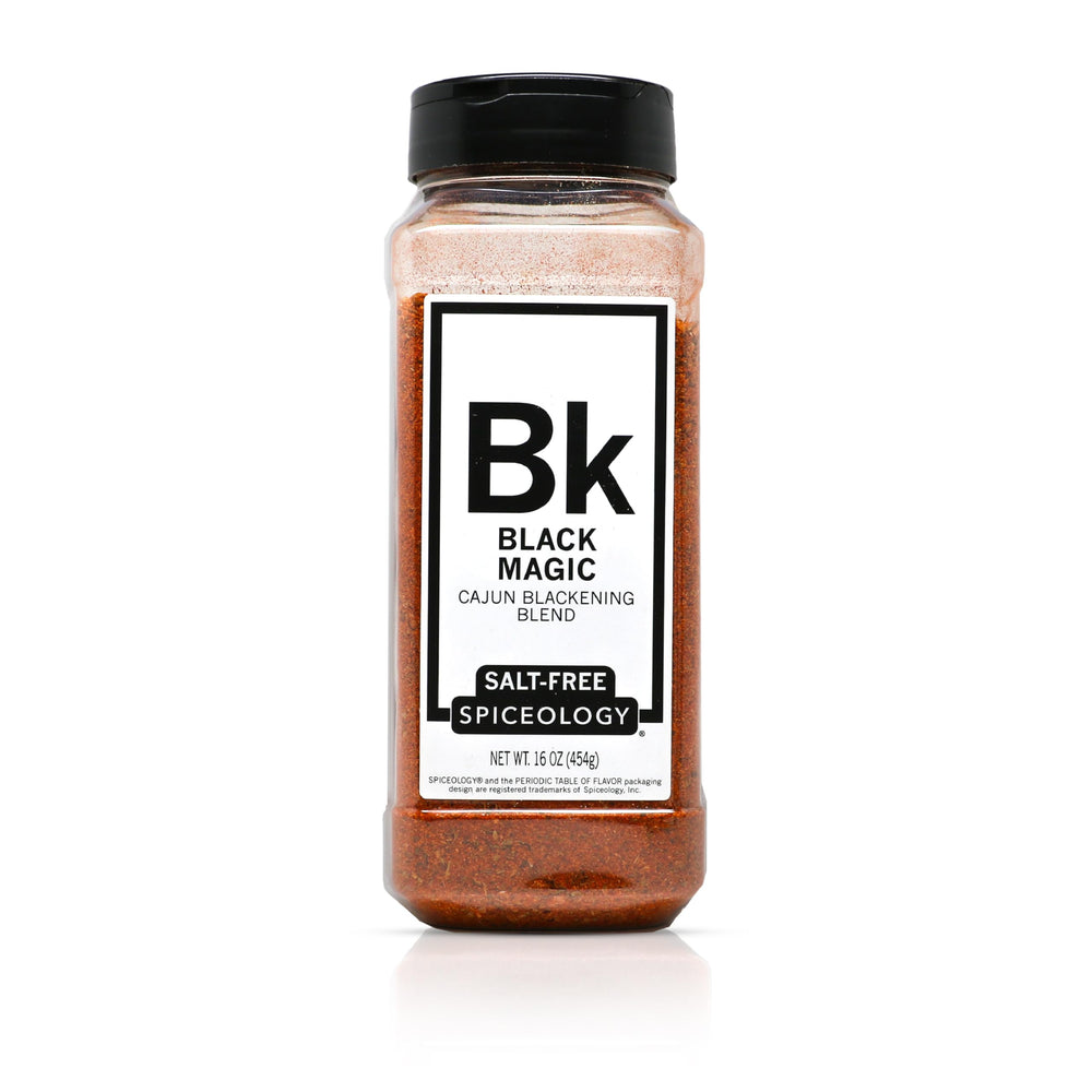 Spiceology Black Magic bottle pour showing salt-free Cajun flavor for grilling