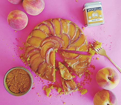 SPICEWALLA Golden Milk powder on a cozy kitchen table scene.