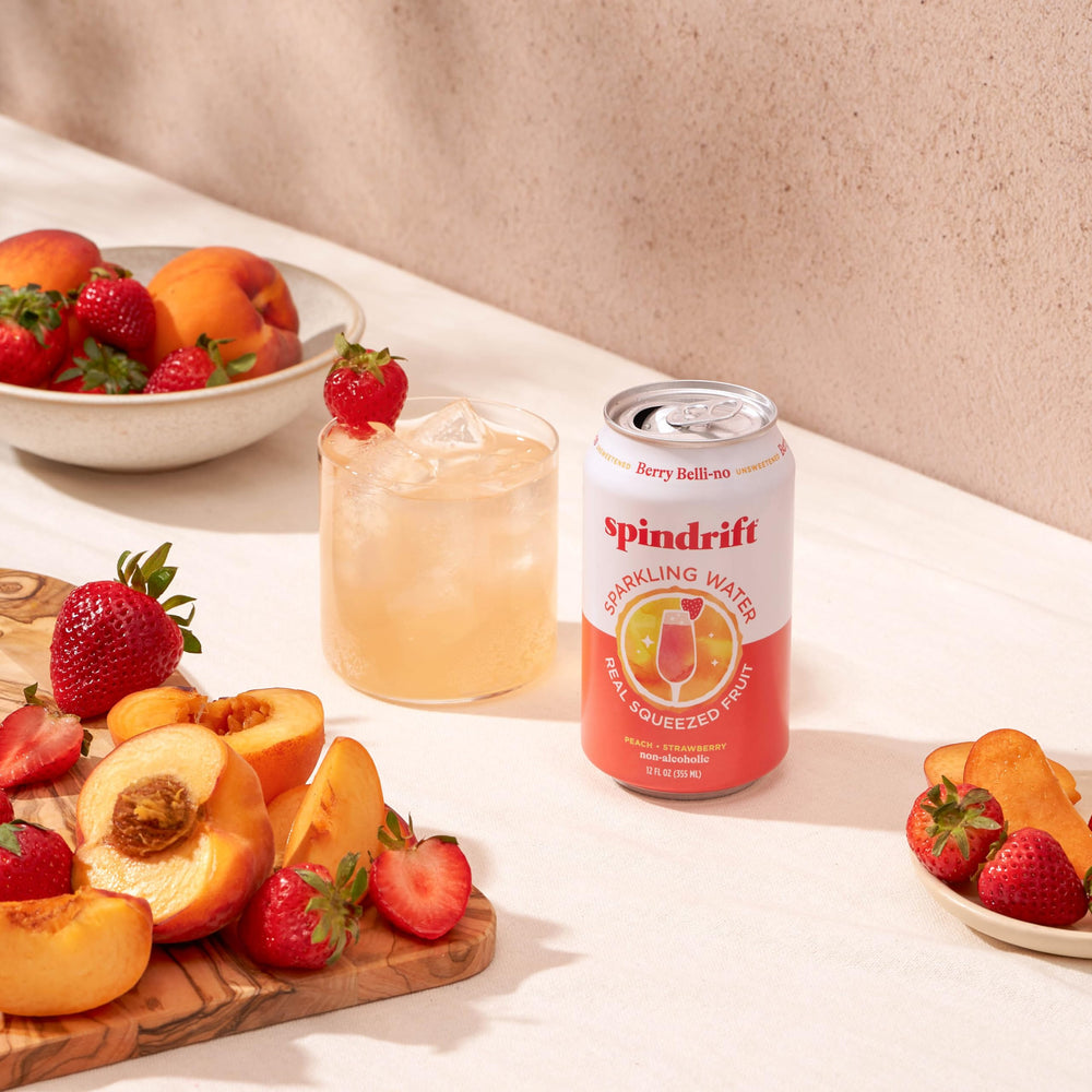 Sparkling water with real fruit beside ice in a glass.