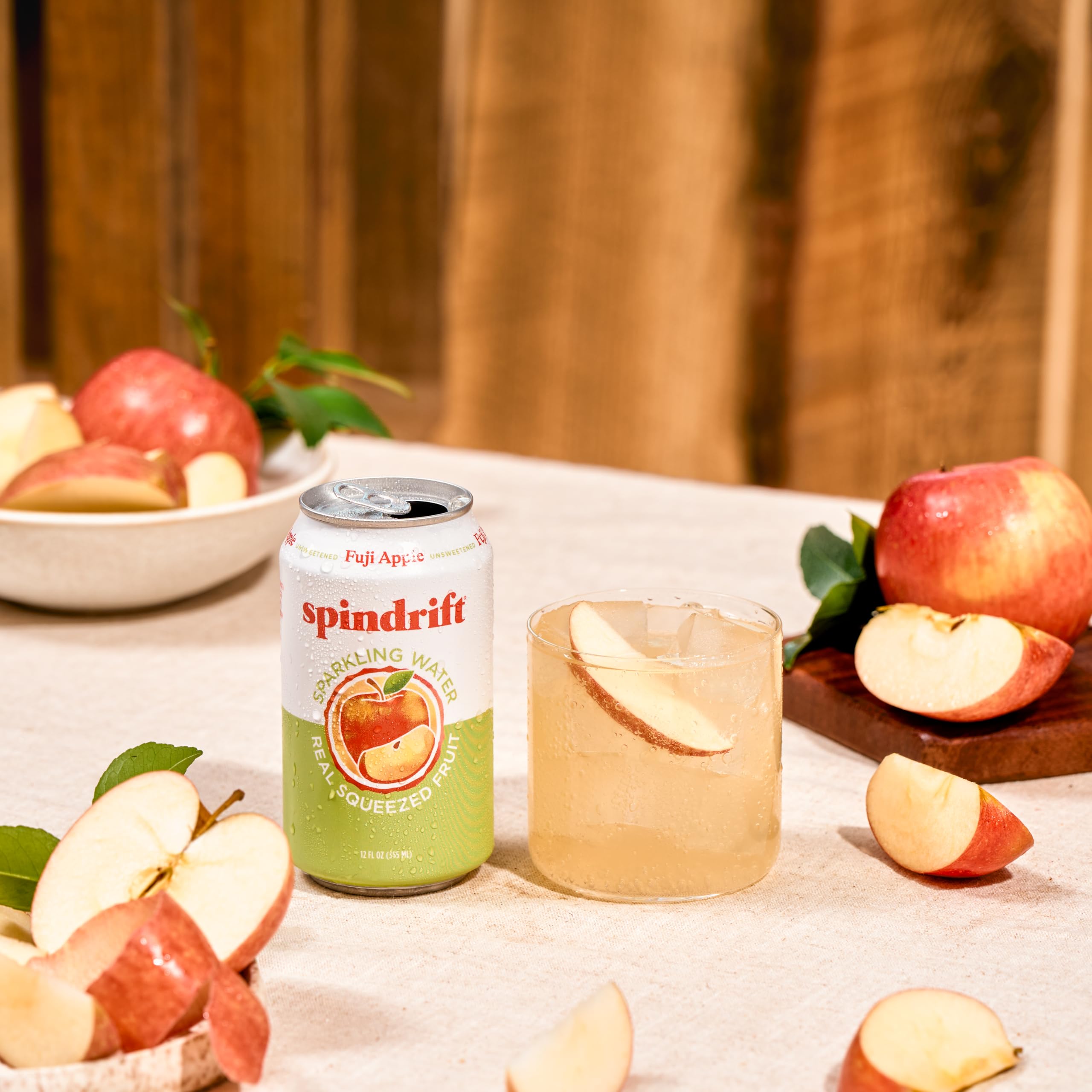 Spindrift Fuji Apple 12-ounce can beside a glass for quick hydration.