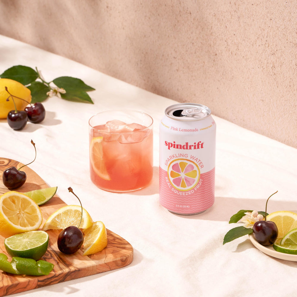 Citrus slices beside Spindrift Pink Lemonade evoke bright, summery flavors