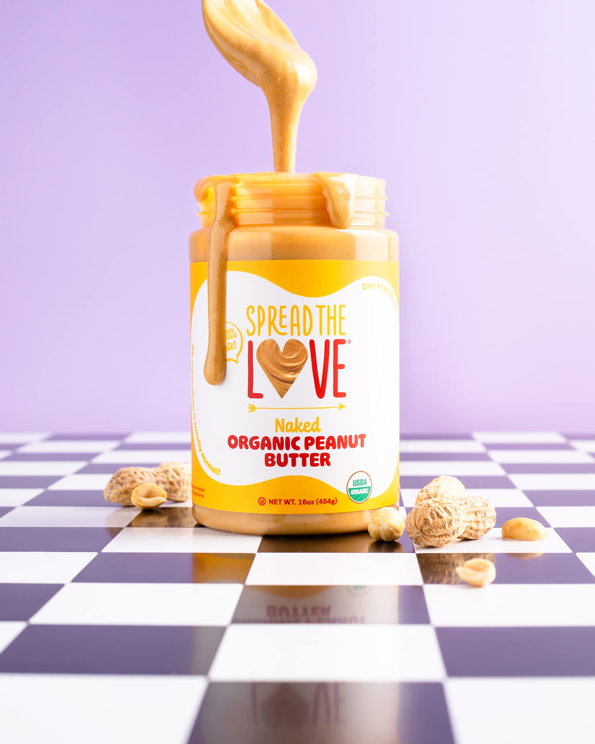 Three-pack of Spread The Love Naked Organic Peanut Butter on a store shelf