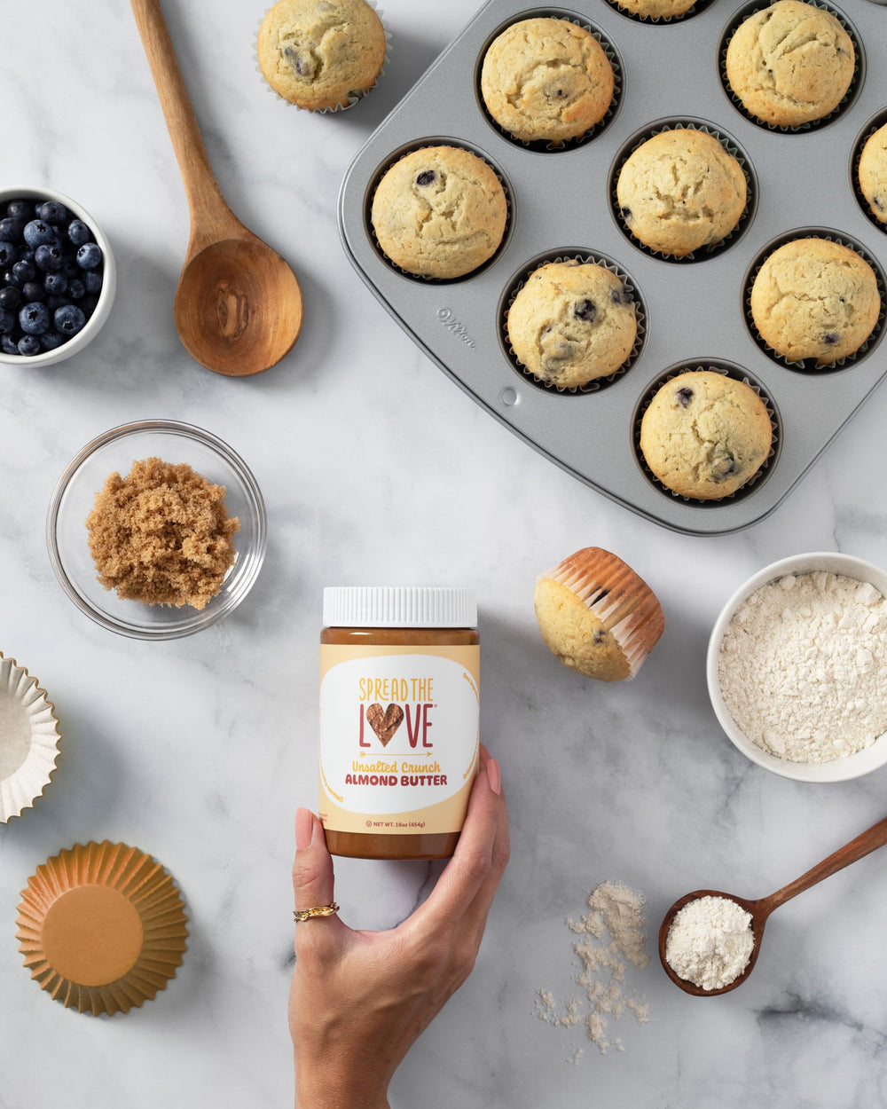 Spread The Love unsalted crunch almond butter packaging highlighting California origin.
