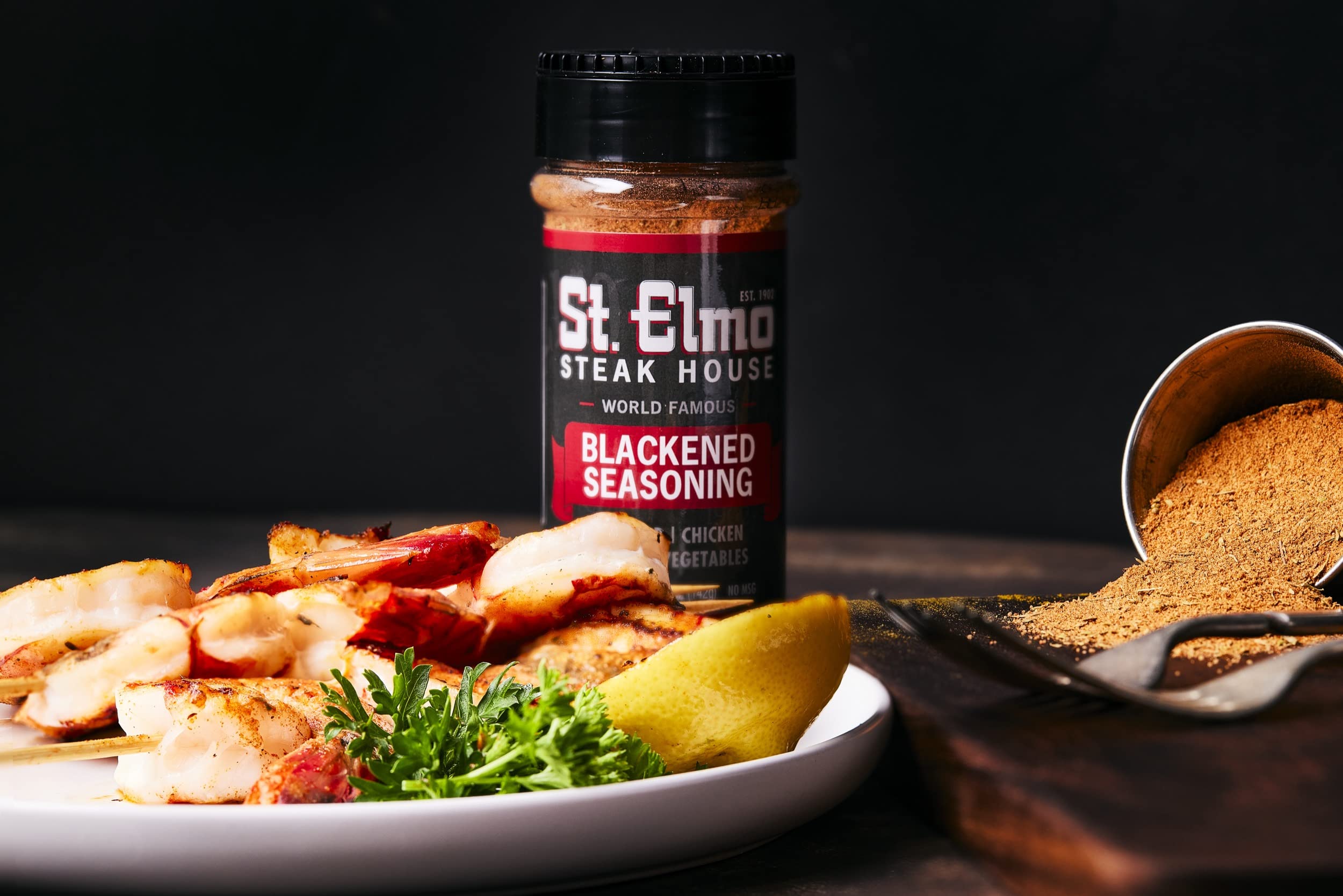 St. Elmo Blackened Seasoning pour shows rich paprika and garlic aroma enhancing dishes.
