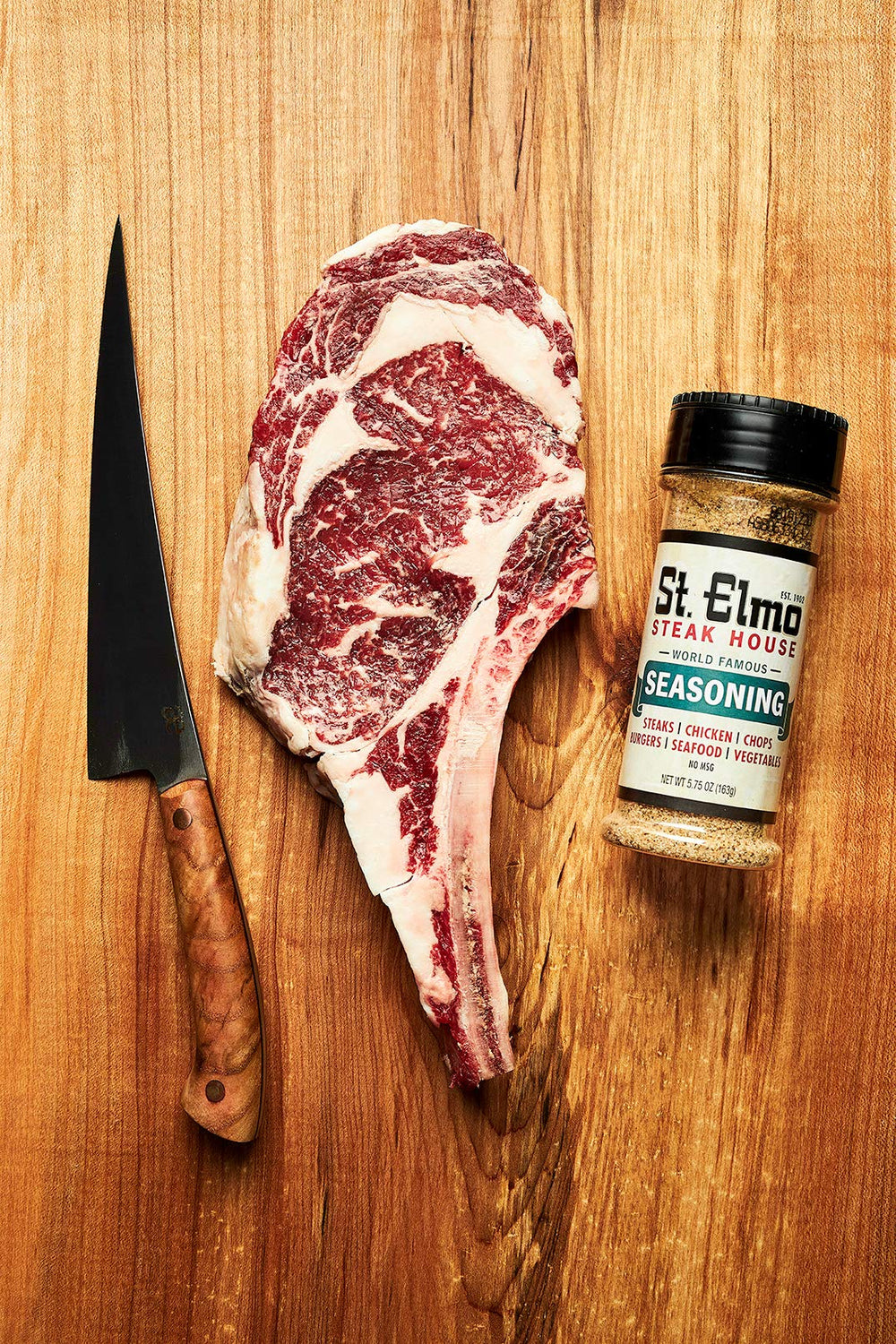 St Elmo Steak House seasoning jar closeup showing paprika and sea salt.