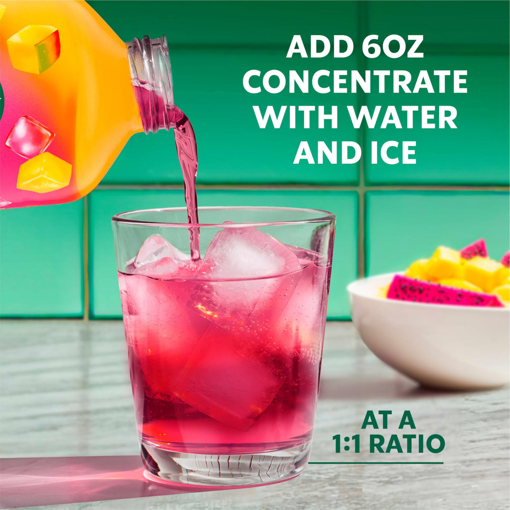 Glass with the bright drink and straw showcasing tropical hues