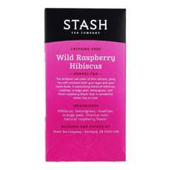 Stash Tea Wild Raspberry Hibiscus infusion in a glass with a vibrant hue.