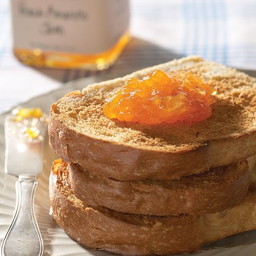 Stonewall Kitchen Peach Amaretto Jam bottle pouring over warm waffles