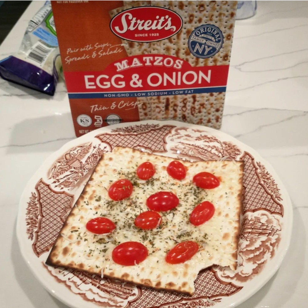 Streit's Egg & Onion Matzo arranged with cheeses for a platter