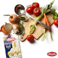 Streit's Matzo Ball Mix being mixed with eggs and oil in a bowl.