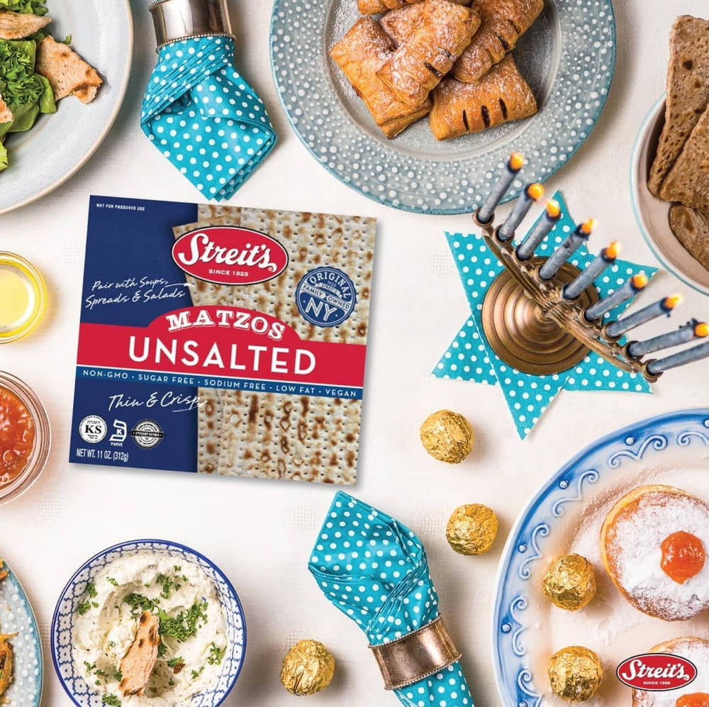 Thin, crisp matzo pieces beside a bowl, highlighting a neutral taste.