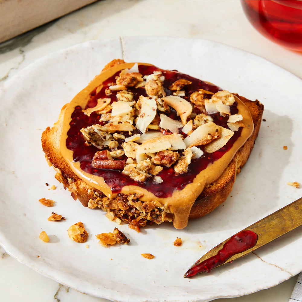 Struesli Original granola on pancake stack signals breakfast friendly crunch.