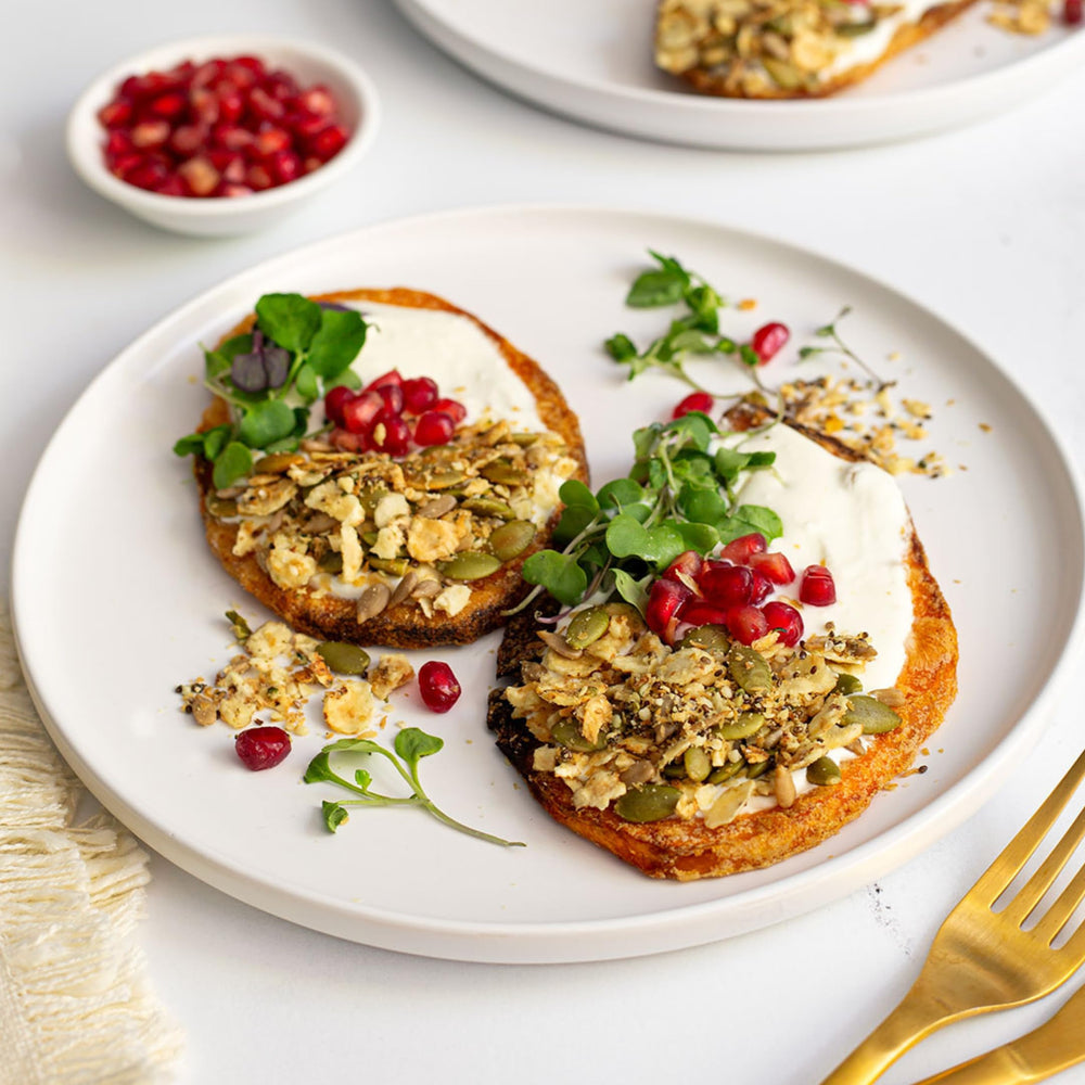 Struesli Savory + Seed Granola on avocado toast—savory crunch topping.