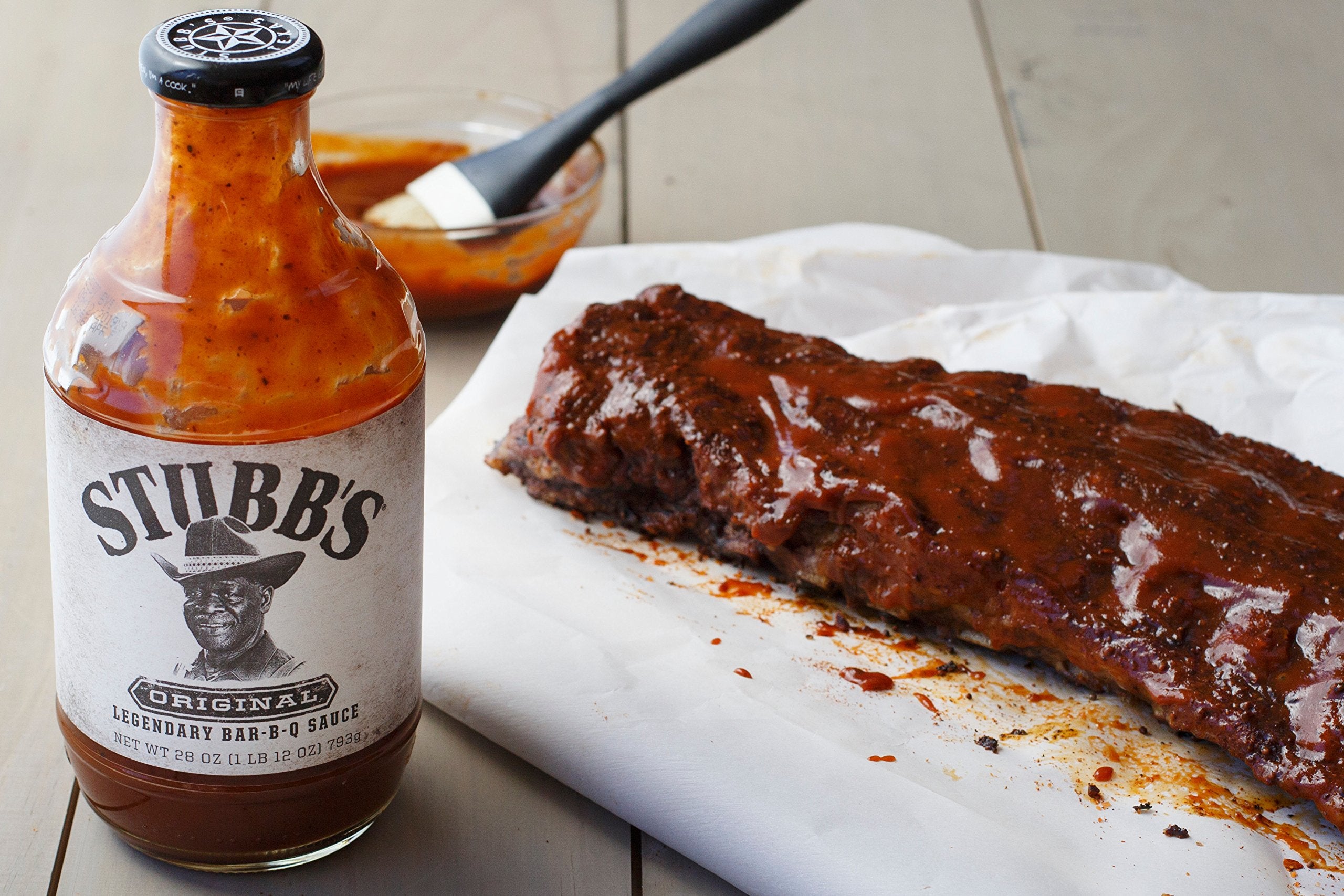 Backyard barbecue scene featuring Stubb's sauce in action.