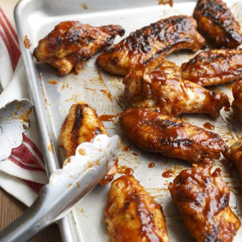 Plate with ribs, chicken, and vegetables featuring Stubbs sauce glaze.