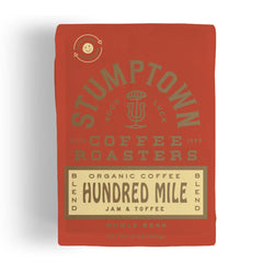 Stumptown Hundred Mile organic whole bean coffee bag front label showing jam and toffee notes, breakfast-friendly.