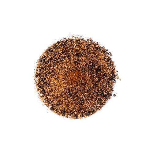 Pouring SuckleBusters 1836 Beef Rub for even coverage