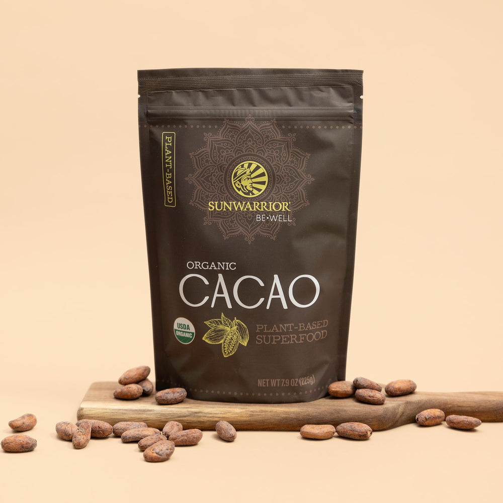 Sunwarrior Pure Cacao Powder added to a blender bottle for a smoothie.