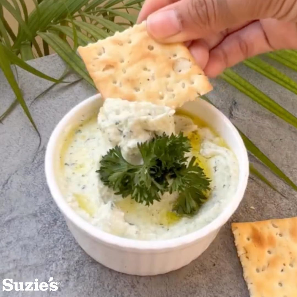 Suzie's Organic Saltines texture closeup—golden crackers with rich olive oil aroma.