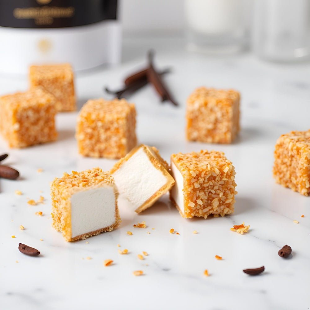 SweetGourmet vanilla marshmallow cubes with coconut coating for gourmet snacking.