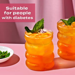 Sweet'N Low strawberry liquid poured into iced tea for a refreshing serving.
