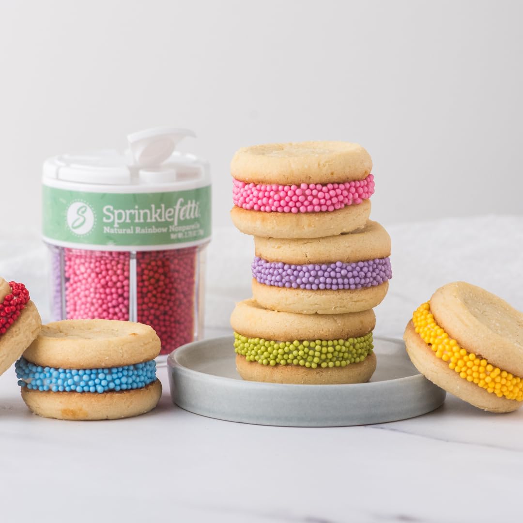 Sweets Indeed cake and donuts topped with rainbow nonpareils for celebration-ready visuals.