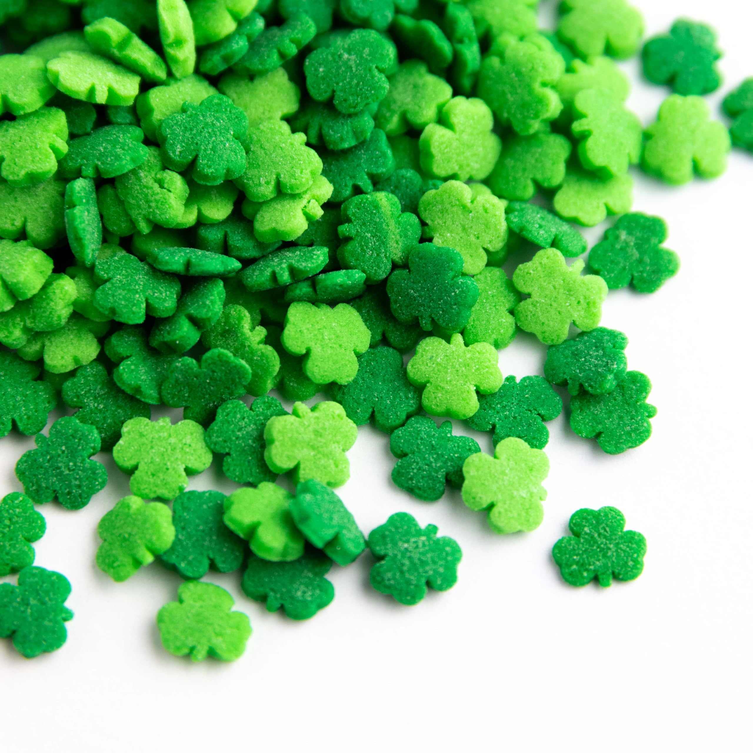 Sweets Indeed shamrock sprinkles on cakes showcase bold green contrast.