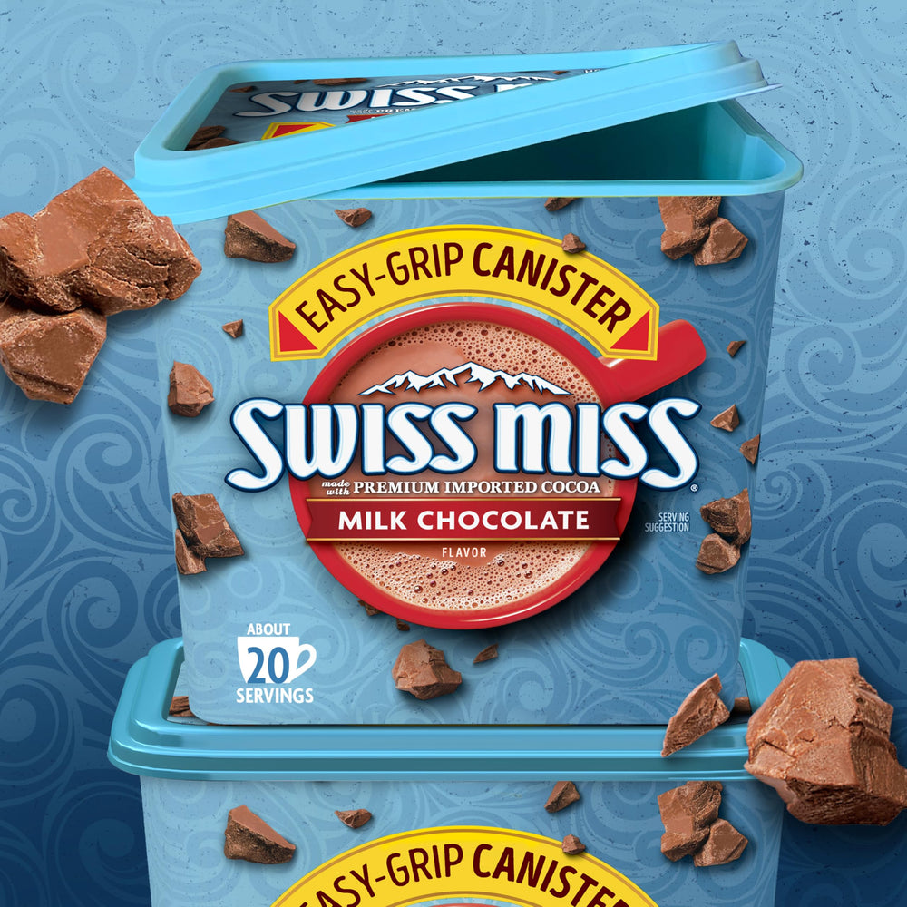 Swiss Miss cocoa with marshmallows beside mug, cozy treat.