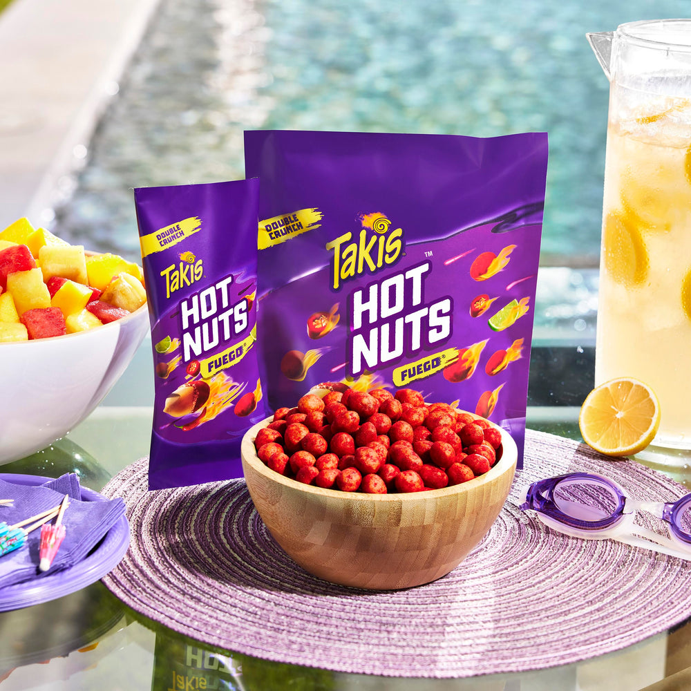 Takis Fuego Hot Nuts seasoning detail shows chili pepper and lime coating