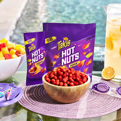 Takis Fuego Hot Nuts seasoning detail shows chili pepper and lime coating
