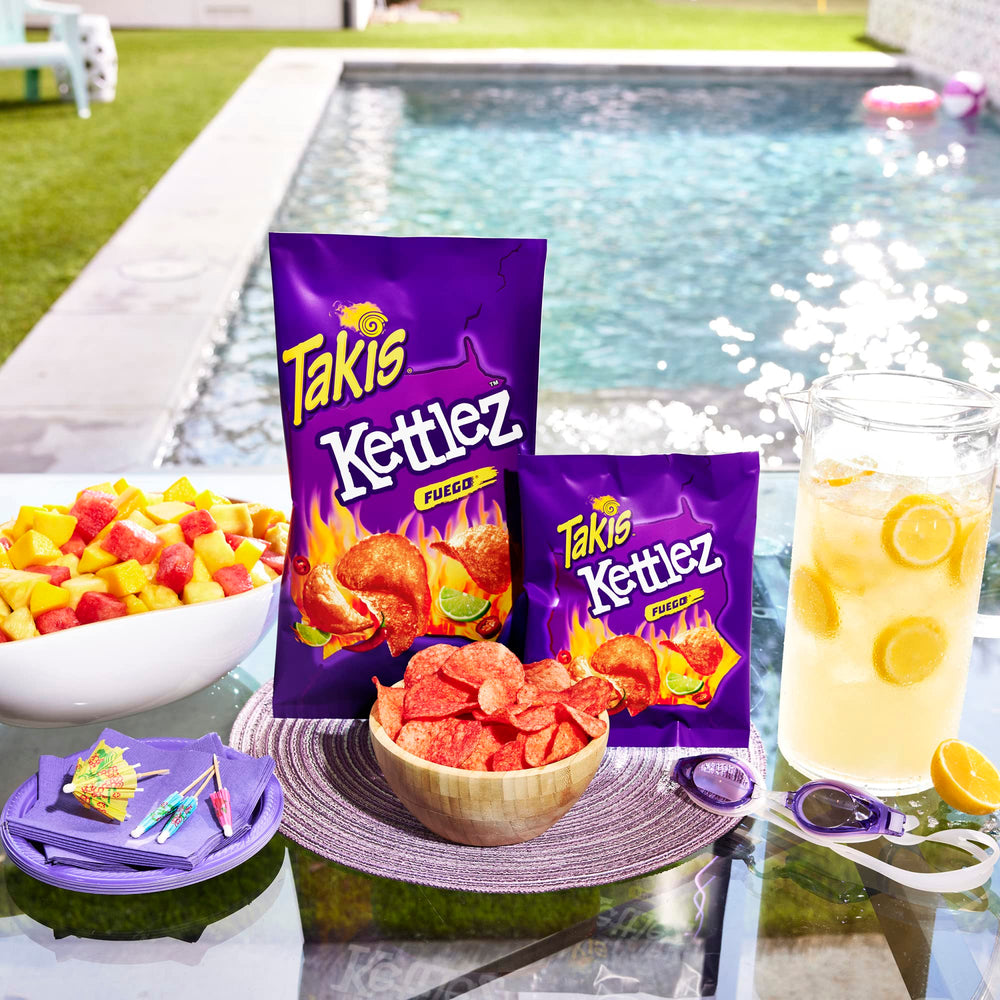 Takis Fuego bag held in hand showing 8 oz sharing size convenience
