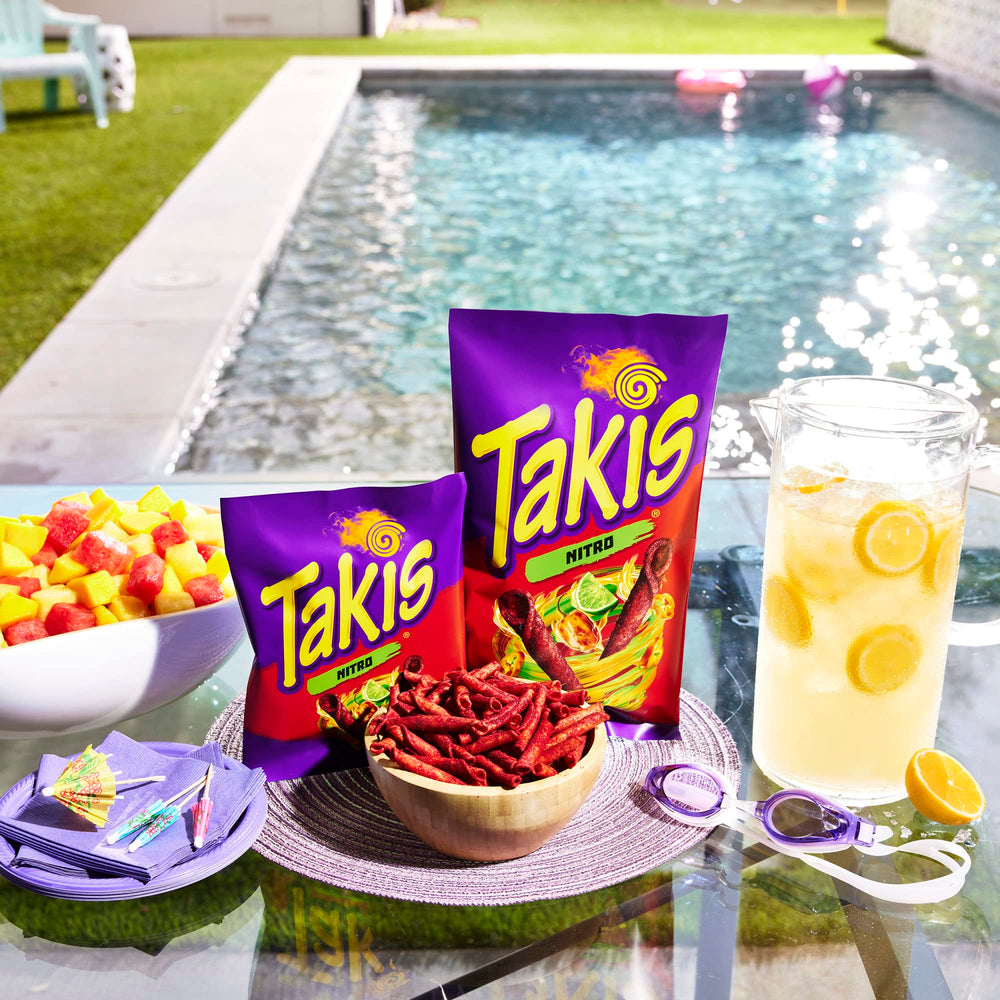 Hand holding Takis bag to show 9.9 oz sharing size and portion clarity