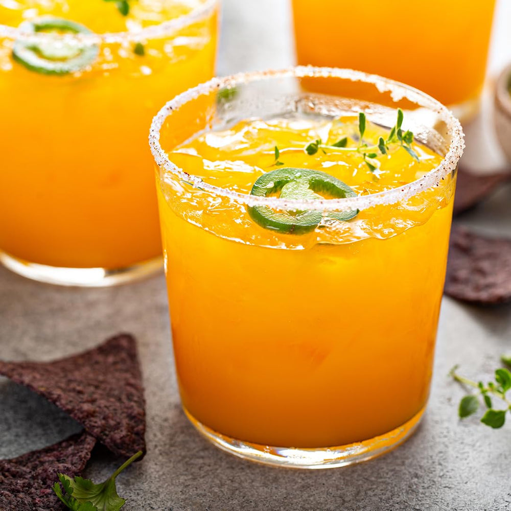 Taoro Mango Nectar bottle beside fresh mango for delicious flavor inspiration.