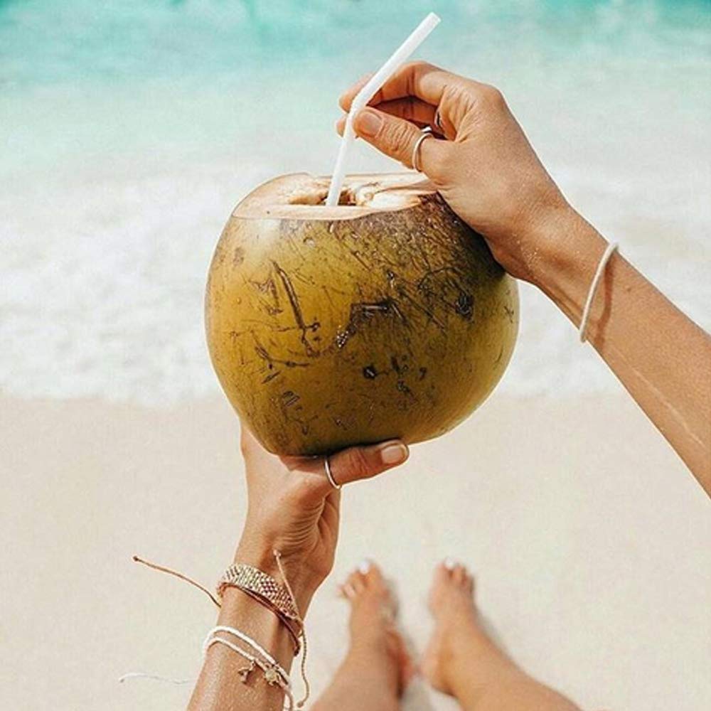 Taste Nirvana Real Coconut Water on wood surface